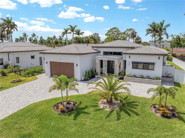 1324 Longwood Dr, Fort Myers, FL 33919 - prairie-style home featuring an attached garage, decorative driveway, a tile roof, and stucco siding