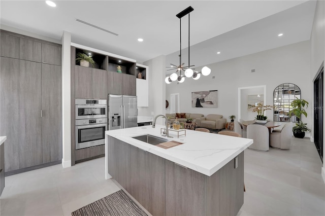 1324 Longwood Dr, Fort Myers, FL 33919 - kitchen with a sink, modern cabinets, stainless steel appliances, open floor plan, and a center island with sink