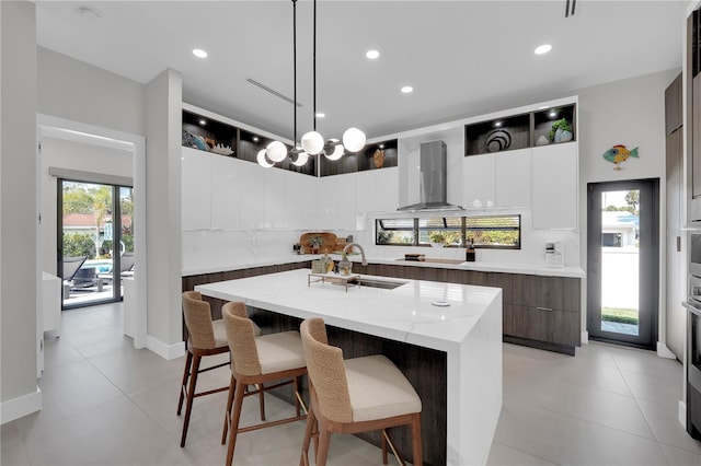 1324 Longwood Dr, Fort Myers, FL 33919 - kitchen featuring ventilation hood, a sink, modern cabinets, an island with sink, and decorative light fixtures