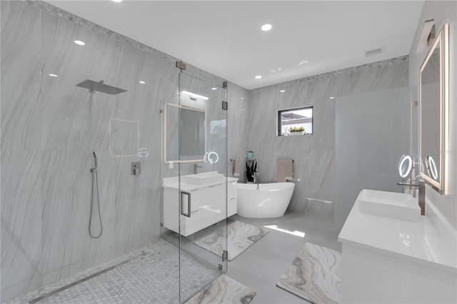 1324 Longwood Dr, Fort Myers, FL 33919 - full bath featuring a marble finish shower, a soaking tub, double vanity, tile walls, and recessed lighting