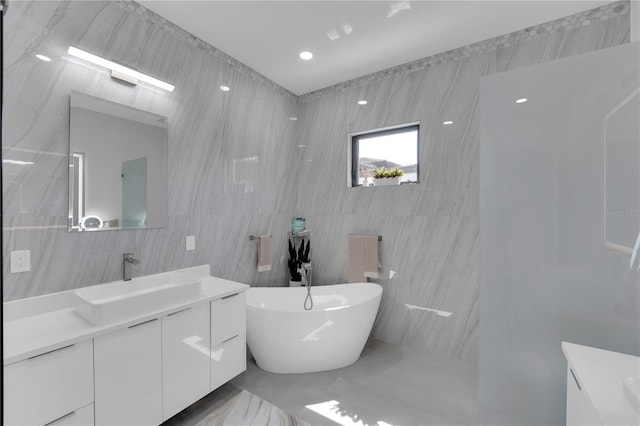 1324 Longwood Dr, Fort Myers, FL 33919 - full bathroom featuring tile walls, vanity, a freestanding tub, and marble finish floors