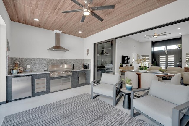 1324 Longwood Dr, Fort Myers, FL 33919 - kitchen with wall chimney range hood, ceiling fan, refrigerator, light countertops, and recessed lighting