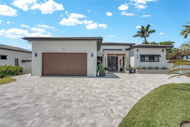 1324 Longwood Dr, Fort Myers, FL 33919 - view of front facade featuring stucco siding, a garage, decorative driveway, french doors, and a tile roof