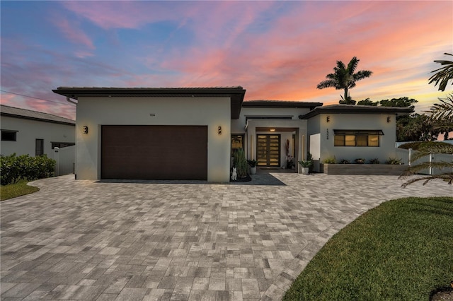 1324 Longwood Dr, Fort Myers, FL 33919 - view of front of property featuring french doors, stucco siding, decorative driveway, a garage, and a tiled roof