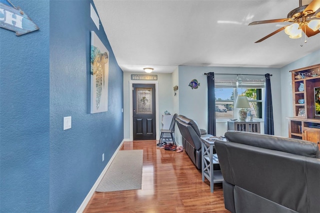 566 Reading St NW, Port Charlotte, FL 33952 - living area featuring ceiling fan, wood finished floors, baseboards, and a textured wall