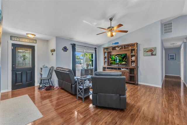 566 Reading St NW, Port Charlotte, FL 33952 - living room with vaulted ceiling, wood finished floors, a ceiling fan, and baseboards