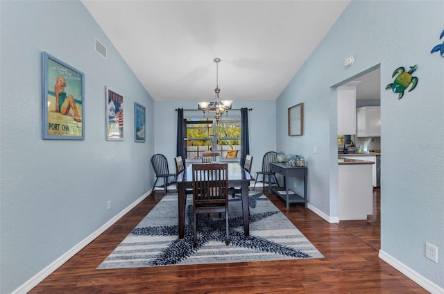 566 Reading St NW, Port Charlotte, FL 33952 - dining room featuring lofted ceiling, a chandelier, dark wood-style flooring, and baseboards