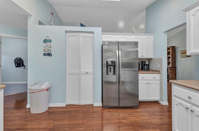 566 Reading St NW, Port Charlotte, FL 33952 - kitchen featuring stainless steel fridge, white cabinetry, wood finished floors, and light countertops
