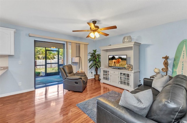 566 Reading St NW, Port Charlotte, FL 33952 - living area with a ceiling fan, light wood-style flooring, and baseboards