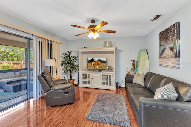 566 Reading St NW, Port Charlotte, FL 33952 - living room with light wood-style flooring and ceiling fan