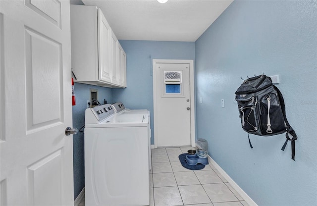 566 Reading St NW, Port Charlotte, FL 33952 - washroom with cabinet space, washer and dryer, baseboards, and light tile patterned floors