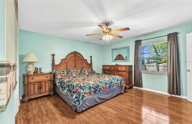 566 Reading St NW, Port Charlotte, FL 33952 - bedroom featuring wood finished floors, baseboards, ceiling fan, and a textured ceiling