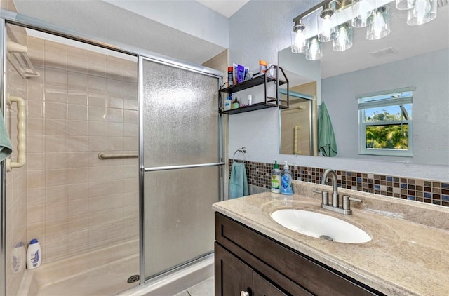 566 Reading St NW, Port Charlotte, FL 33952 - bathroom with vanity, a shower stall, and backsplash