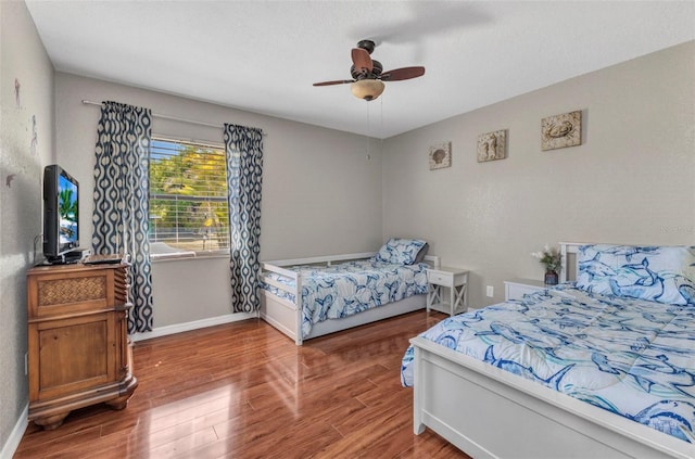566 Reading St NW, Port Charlotte, FL 33952 - bedroom with wood finished floors, baseboards, and a ceiling fan