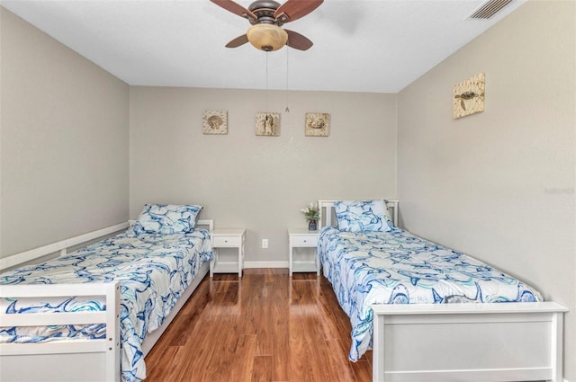 566 Reading St NW, Port Charlotte, FL 33952 - bedroom with wood finished floors, baseboards, and a ceiling fan