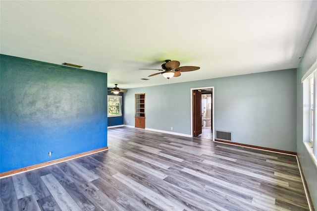 4707 Southgate Dr, Jacksonville, FL 32207 - empty room with wood finished floors, ceiling fan, and baseboards