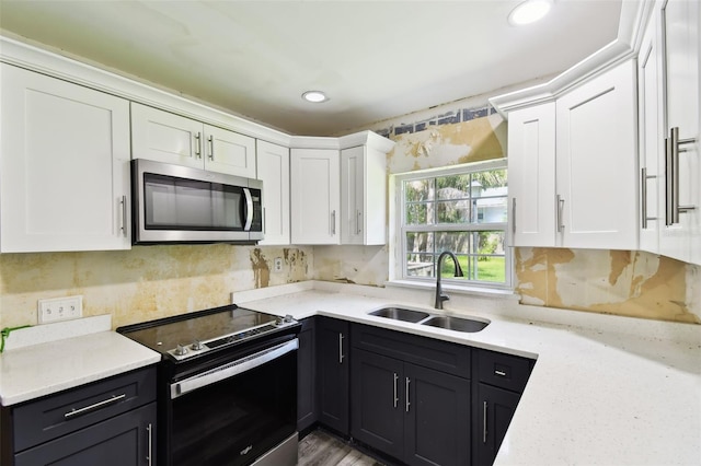 4707 Southgate Dr, Jacksonville, FL 32207 - kitchen with stainless steel appliances, a sink, white cabinets, tasteful backsplash, and recessed lighting
