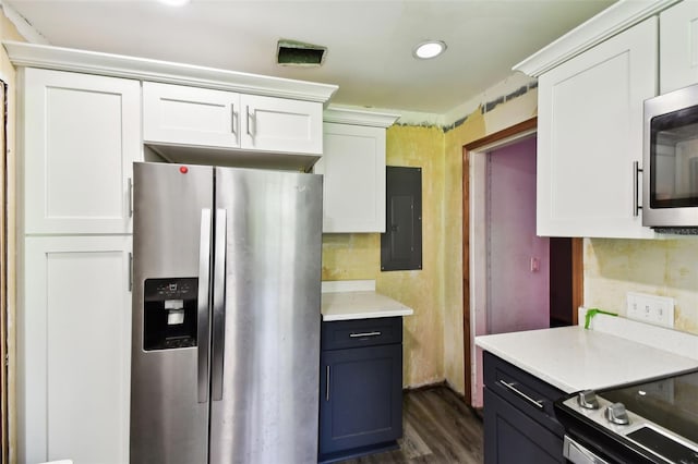4707 Southgate Dr, Jacksonville, FL 32207 - kitchen with appliances with stainless steel finishes, electric panel, white cabinets, dark wood-type flooring, and light countertops