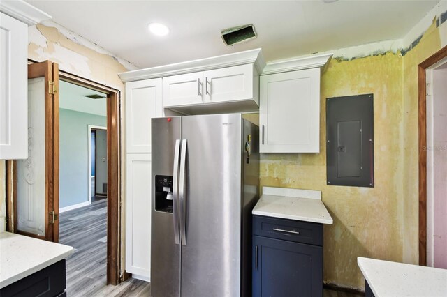 4707 Southgate Dr, Jacksonville, FL 32207 - kitchen with stainless steel refrigerator with ice dispenser, electric panel, white cabinets, wood finished floors, and baseboards
