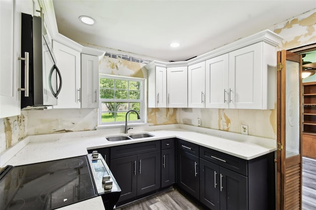 4707 Southgate Dr, Jacksonville, FL 32207 - kitchen featuring a sink, black range with electric stovetop, white cabinets, stainless steel microwave, and recessed lighting