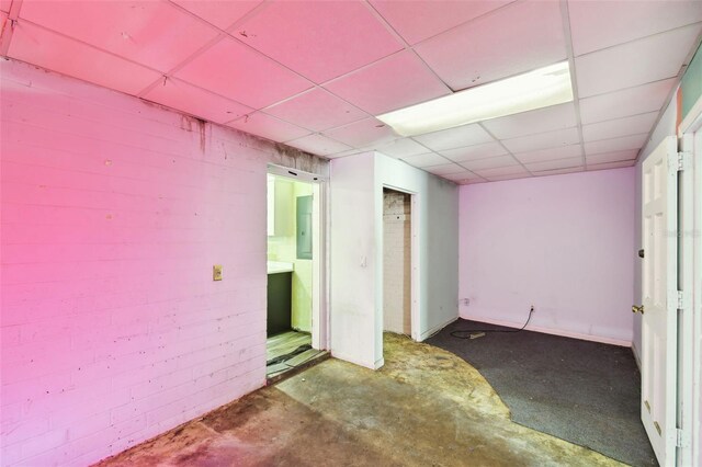 4707 Southgate Dr, Jacksonville, FL 32207 - spare room with a drop ceiling, electric panel, and concrete floors