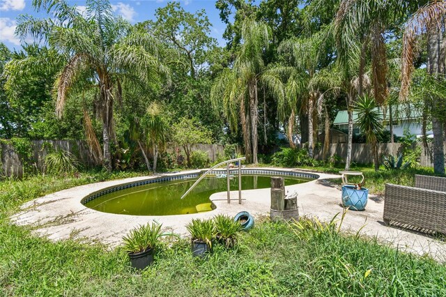 4707 Southgate Dr, Jacksonville, FL 32207 - view of property's community featuring a fenced backyard, a pool, a patio, and a small pond