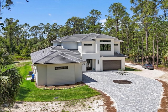 3632 Golden Gate Blvd W, Naples, FL 34102 - contemporary house with stucco siding, a tiled roof, driveway, and an attached garage