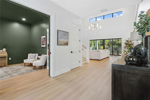 3632 Golden Gate Blvd W, Naples, FL 34102 - foyer entrance featuring light wood-style flooring, a chandelier, stairs, and baseboards