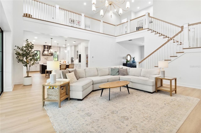 3632 Golden Gate Blvd W, Naples, FL 34102 - living area featuring light wood-type flooring, a chandelier, a towering ceiling, stairway, and recessed lighting