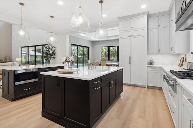 3632 Golden Gate Blvd W, Naples, FL 34102 - kitchen with a kitchen island, stainless steel appliances, dark cabinets, and recessed lighting