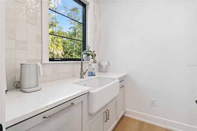 3632 Golden Gate Blvd W, Naples, FL 34102 - bathroom featuring vanity, baseboards, wood finished floors, and decorative backsplash