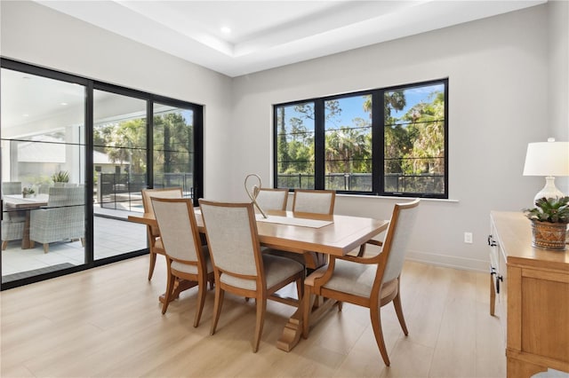 3632 Golden Gate Blvd W, Naples, FL 34102 - dining space with light wood-style flooring, a tray ceiling, recessed lighting, and baseboards