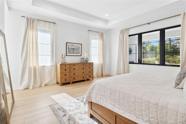 3632 Golden Gate Blvd W, Naples, FL 34102 - bedroom featuring a raised ceiling, light wood-style floors, recessed lighting, and baseboards