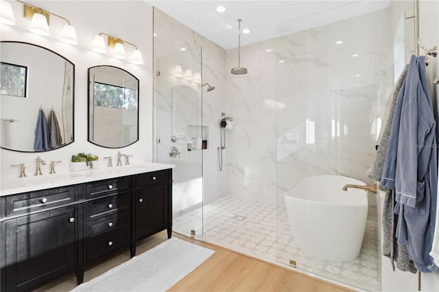 3632 Golden Gate Blvd W, Naples, FL 34102 - full bath with a marble finish shower, a freestanding tub, double vanity, wood finished floors, and recessed lighting