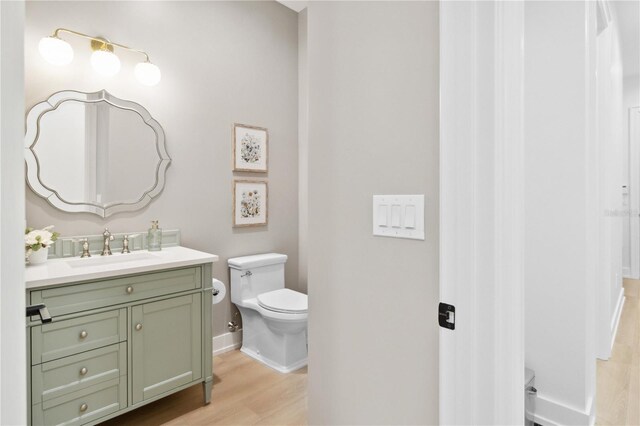 3632 Golden Gate Blvd W, Naples, FL 34102 - half bath with toilet, vanity, wood finished floors, and baseboards