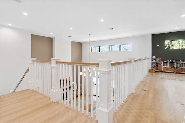3632 Golden Gate Blvd W, Naples, FL 34102 - hallway featuring an upstairs landing, wood finished floors, recessed lighting, and healthy amount of natural light