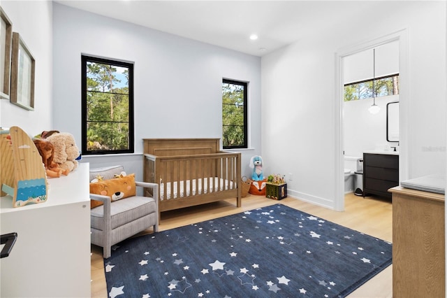 3632 Golden Gate Blvd W, Naples, FL 34102 - bedroom with wood finished floors, recessed lighting, a nursery area, and baseboards