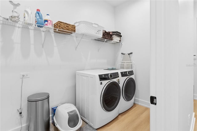 3632 Golden Gate Blvd W, Naples, FL 34102 - washroom featuring washer and clothes dryer, light wood-style flooring, and baseboards