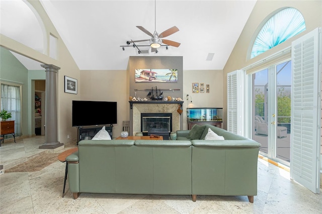 5219 Guava Ter, Port Charlotte, FL 33981 - living room featuring decorative columns, high vaulted ceiling, a ceiling fan, and a fireplace