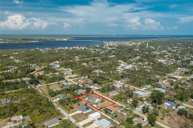 5219 Guava Ter, Port Charlotte, FL 33981 - aerial view of property and surrounding area featuring property boundaries highlighted, a large body of water, and nearby suburban area