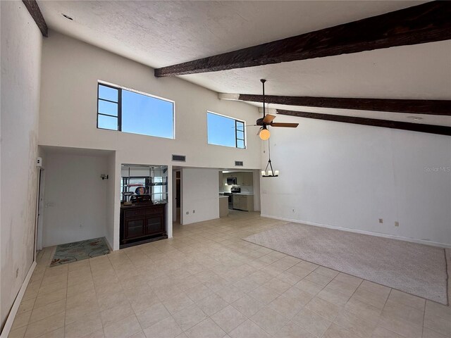 25188 Marion Ave Unit 1, Punta Gorda, FL 33950 - unfurnished living room featuring high vaulted ceiling, a ceiling fan, beam ceiling, a textured ceiling, and baseboards