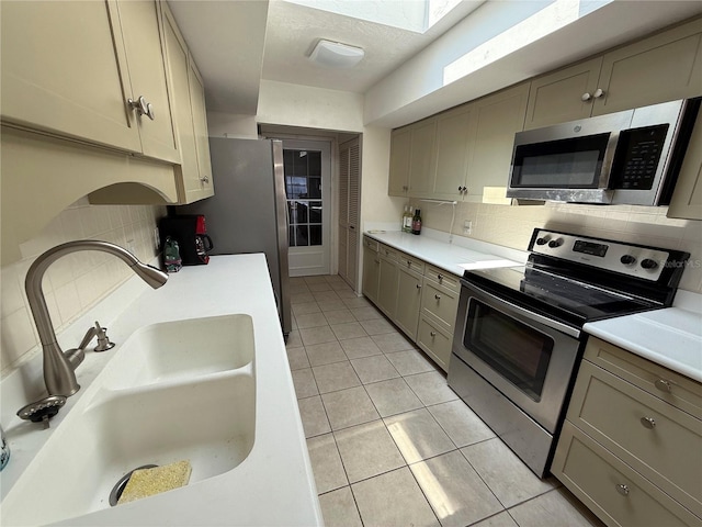 25188 Marion Ave Unit 1, Punta Gorda, FL 33950 - kitchen featuring stainless steel appliances, a sink, gray cabinetry, backsplash, and light tile patterned floors