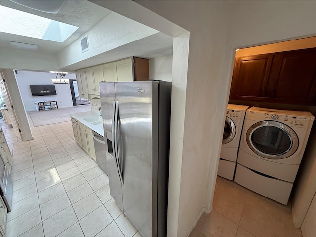 25188 Marion Ave Unit 1, Punta Gorda, FL 33950 - laundry room with washing machine and clothes dryer, light tile patterned flooring, a skylight, and a chandelier