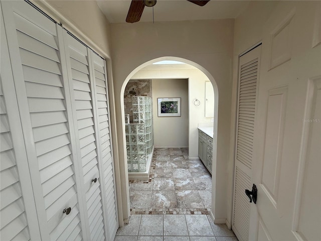 25188 Marion Ave Unit 1, Punta Gorda, FL 33950 - hallway with arched walkways, stone tile floors, and baseboards