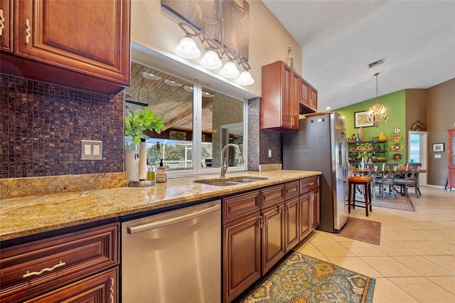 5600 Blackjack Ct S, Punta Gorda, FL 33982 - kitchen featuring appliances with stainless steel finishes, a sink, backsplash, a chandelier, and light tile patterned floors