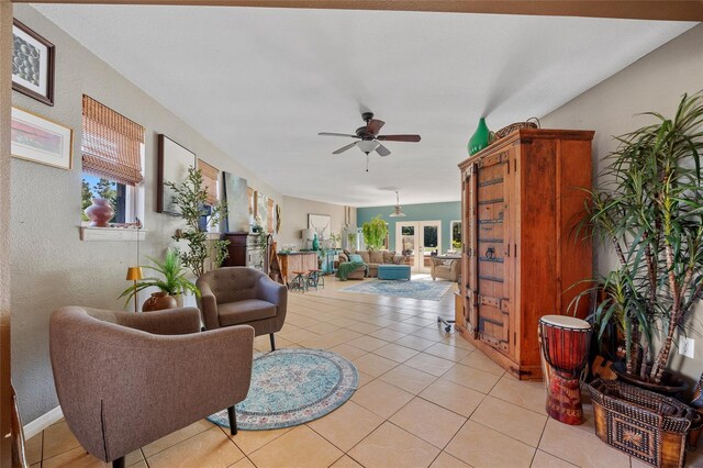 5600 Blackjack Ct S, Punta Gorda, FL 33982 - living area featuring a ceiling fan, light tile patterned floors, and a textured wall