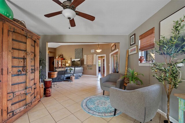 5600 Blackjack Ct S, Punta Gorda, FL 33982 - living area featuring light tile patterned floors, a ceiling fan, and baseboards