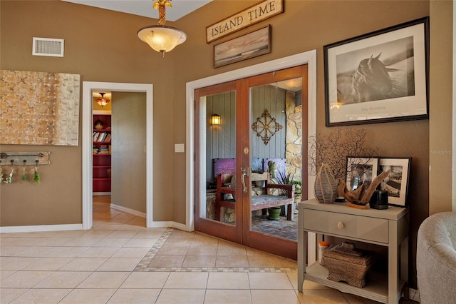 5600 Blackjack Ct S, Punta Gorda, FL 33982 - entryway featuring french doors, light tile patterned floors, and baseboards