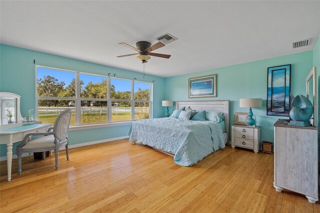 5600 Blackjack Ct S, Punta Gorda, FL 33982 - bedroom featuring light wood-type flooring, multiple windows, baseboards, and a ceiling fan