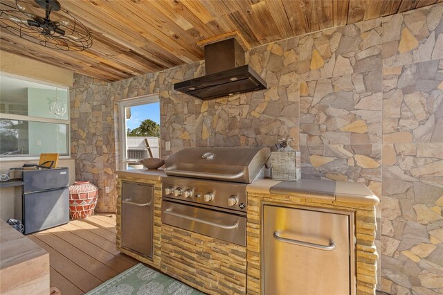 5600 Blackjack Ct S, Punta Gorda, FL 33982 - kitchen with wall chimney exhaust hood, wooden ceiling, wood finished floors, and freestanding refrigerator